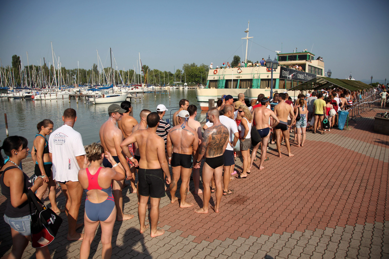 Résztvevők jönnek ki a vízből a balatonboglári Platán strandon a 30. Balaton-átúszáson, miután teljesítették az 5,2 kilométeres távot.